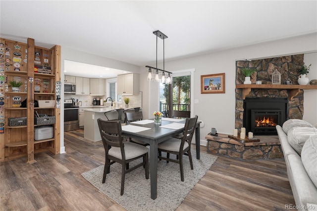 141 Forest Trl # 16, Winter Park, CO 80482 - dining room featuring wood finished floors and a stone fireplace
