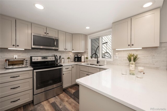 141 Forest Trl # 16, Winter Park, CO 80482 - kitchen with appliances with stainless steel finishes, dark wood-style floors, light countertops, tasteful backsplash, and recessed lighting