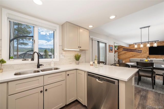 141 Forest Trl # 16, Winter Park, CO 80482 - kitchen with stainless steel dishwasher, wood walls, dark wood-type flooring, light countertops, and a peninsula