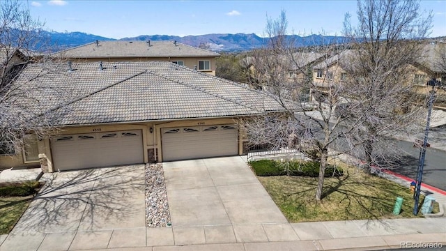 4362 Susie Vw, Colorado Springs, CO 80917 - view of front of property with a mountain view, a tiled roof, concrete driveway, and an attached garage