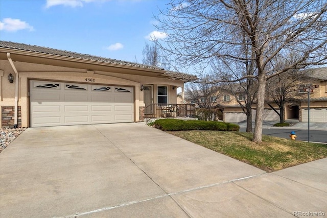 4362 Susie Vw, Colorado Springs, CO 80917 - view of front of property featuring concrete driveway, stucco siding, a tile roof, and a garage