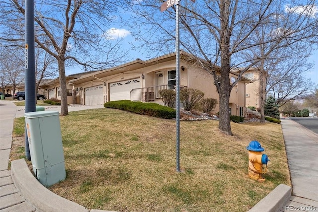 4362 Susie Vw, Colorado Springs, CO 80917 - view of front of property featuring a garage, stucco siding, concrete driveway, and a front lawn