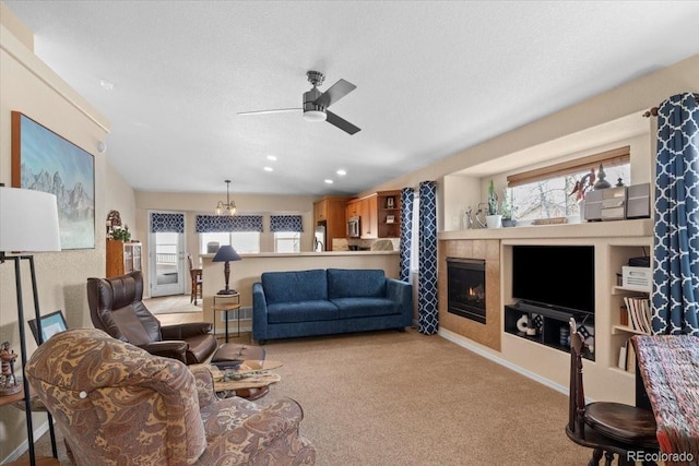4362 Susie Vw, Colorado Springs, CO 80917 - carpeted living area featuring a ceiling fan, a textured ceiling, a tile fireplace, a chandelier, and baseboards