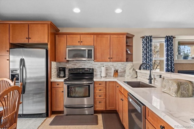 4362 Susie Vw, Colorado Springs, CO 80917 - kitchen with appliances with stainless steel finishes, a sink, brown cabinetry, open shelves, and decorative backsplash
