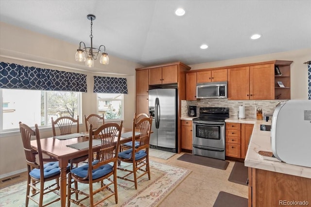 4362 Susie Vw, Colorado Springs, CO 80917 - kitchen with stainless steel appliances, brown cabinetry, open shelves, backsplash, and pendant lighting