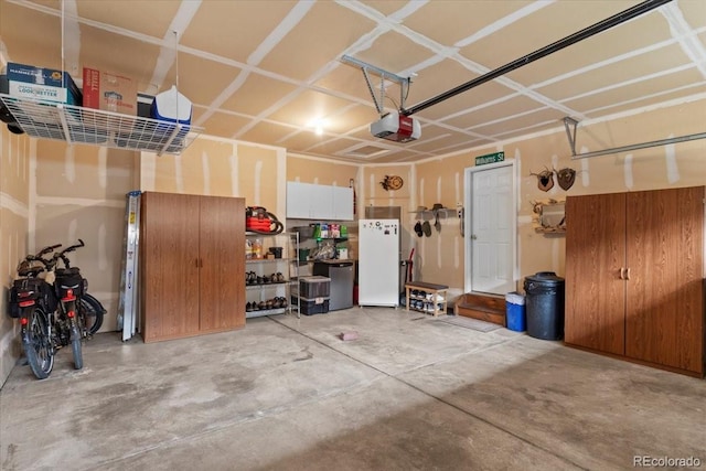 4362 Susie Vw, Colorado Springs, CO 80917 - garage featuring a garage door opener and freestanding refrigerator