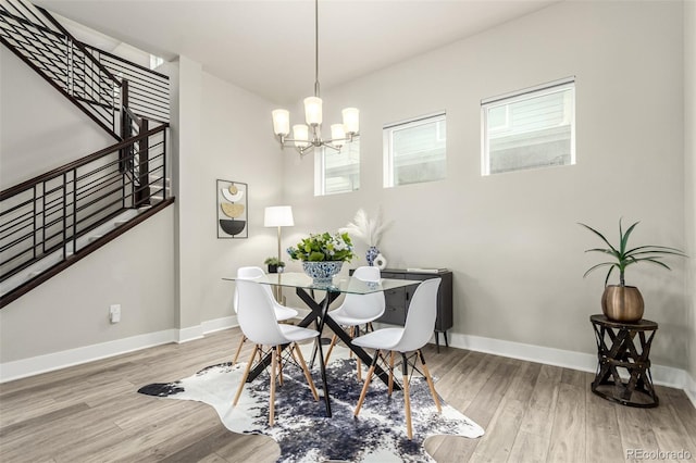 21492 E 60th Ave, Aurora, CO 80019 - dining area with a chandelier, wood finished floors, and baseboards
