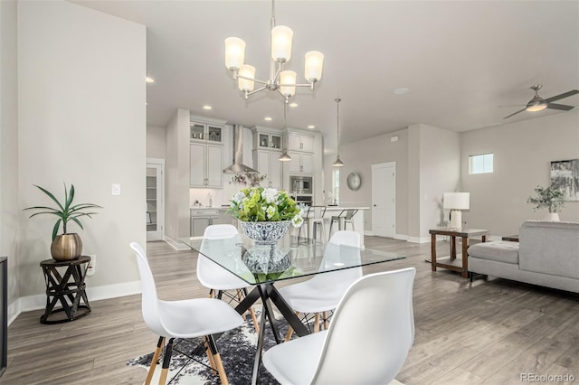21492 E 60th Ave, Aurora, CO 80019 - dining area with ceiling fan with notable chandelier, baseboards, light wood-type flooring, and recessed lighting