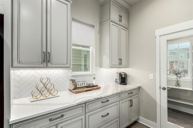 21492 E 60th Ave, Aurora, CO 80019 - kitchen with backsplash, light stone countertops, gray cabinetry, and dark wood-style floors