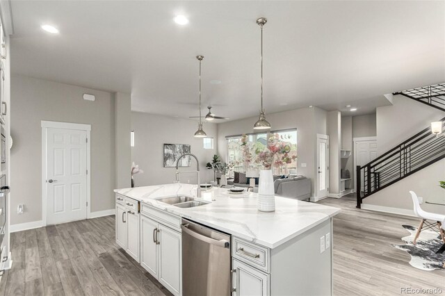 21492 E 60th Ave, Aurora, CO 80019 - kitchen featuring light wood-style flooring, a ceiling fan, an island with sink, a sink, and stainless steel dishwasher