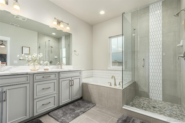 21492 E 60th Ave, Aurora, CO 80019 - bathroom with a sink, a stall shower, tile patterned flooring, double vanity, and a garden tub