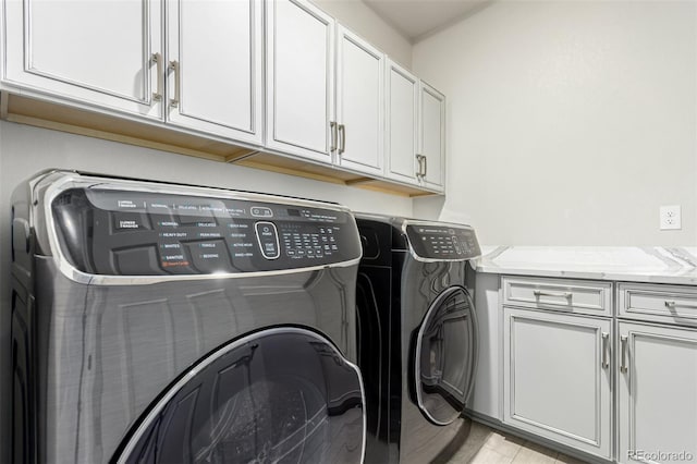 21492 E 60th Ave, Aurora, CO 80019 - laundry room with light wood-style flooring, washing machine and dryer, and cabinet space