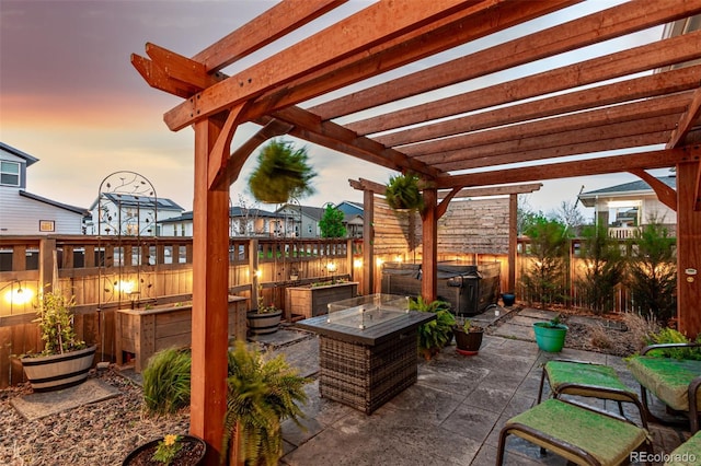 21492 E 60th Ave, Aurora, CO 80019 - patio terrace at dusk featuring a fire pit, a garden, a pergola, and a fenced backyard