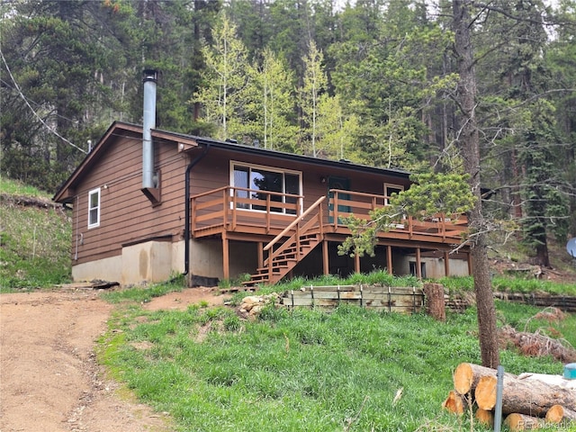 2793 S Beaver Creek Rd, Black Hawk, CO 80422 - view of front of property featuring a wooded view, a wooden deck, and stairway
