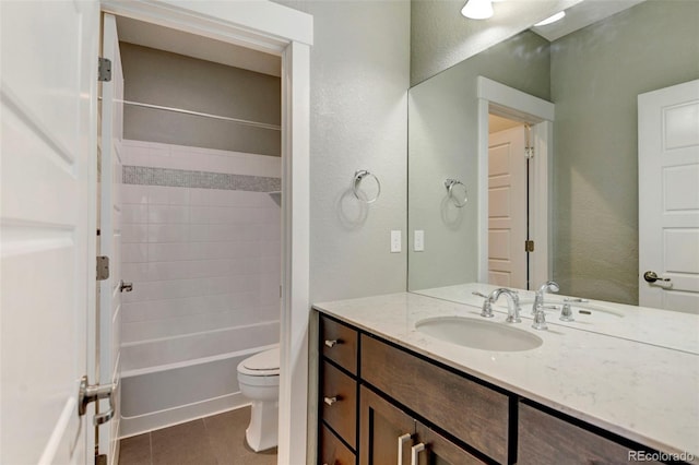 full bathroom with a textured wall, toilet, vanity, tile patterned floors, and shower / bathtub combination