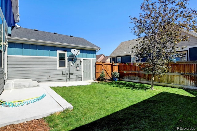 exterior space with board and batten siding, a yard, a patio, and fence