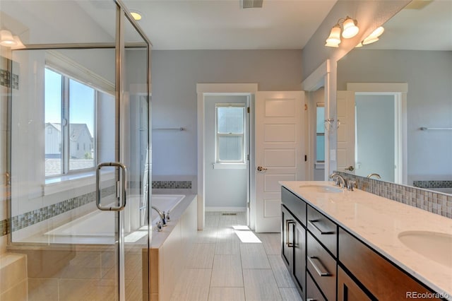 full bath featuring a garden tub, a sink, a shower stall, and double vanity