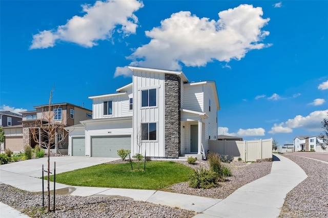 9805 Granite Park Ln, Peyton, CO 80831 - contemporary house with board and batten siding, an attached garage, stone siding, and concrete driveway