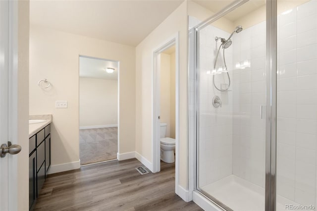 9805 Granite Park Ln, Peyton, CO 80831 - full bath featuring a shower stall, vanity, and wood finished floors