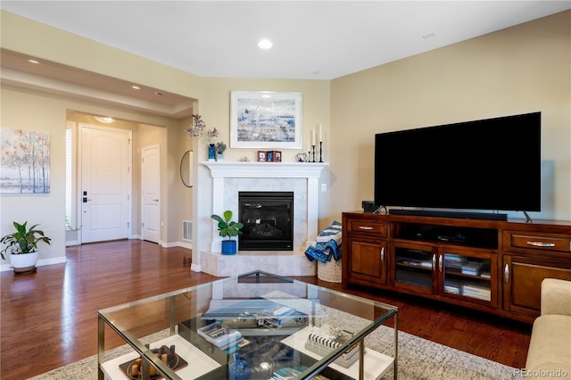10681 Sundial Rim Rd, Highlands Ranch, CO 80126 - living room featuring dark wood-style floors, recessed lighting, a tile fireplace, and baseboards