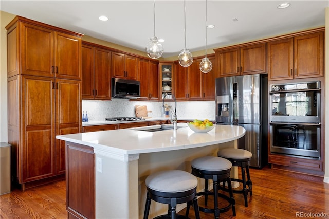 10681 Sundial Rim Rd, Highlands Ranch, CO 80126 - kitchen with appliances with stainless steel finishes, a sink, dark wood-style floors, light countertops, and recessed lighting