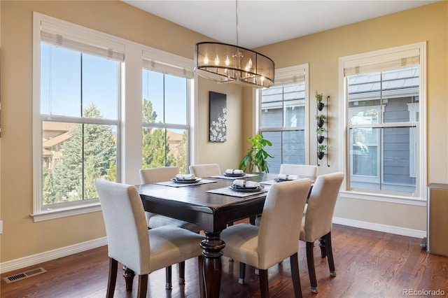 10681 Sundial Rim Rd, Highlands Ranch, CO 80126 - dining space with a chandelier, baseboards, and dark wood finished floors