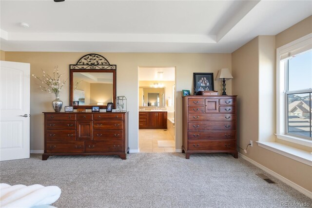10681 Sundial Rim Rd, Highlands Ranch, CO 80126 - bedroom with light colored carpet, baseboards, ensuite bath, and a tray ceiling