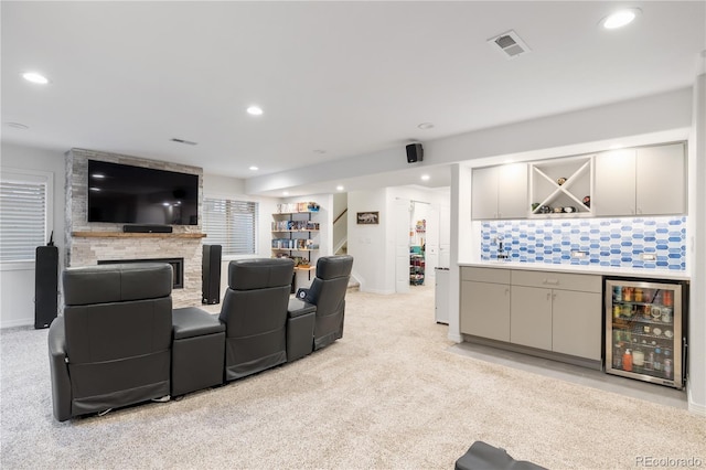 10681 Sundial Rim Rd, Highlands Ranch, CO 80126 - cinema with beverage cooler, a bar, light colored carpet, recessed lighting, and baseboards