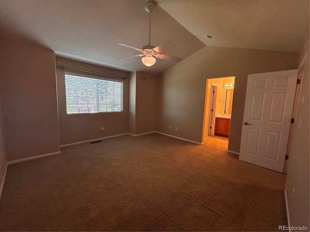 carpeted spare room featuring ceiling fan and vaulted ceiling