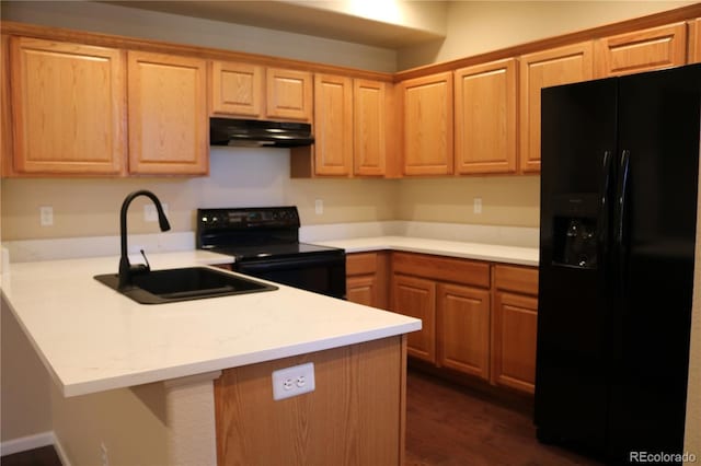 kitchen with kitchen peninsula, sink, black appliances, and dark wood-type flooring