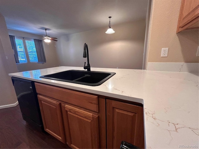 kitchen featuring pendant lighting, dishwasher, sink, ceiling fan, and dark hardwood / wood-style floors