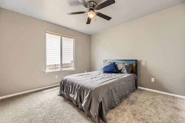 carpeted bedroom featuring baseboards and a ceiling fan