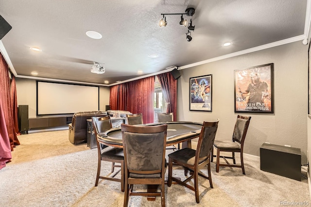 carpeted home theater room with ornamental molding, recessed lighting, and a textured ceiling