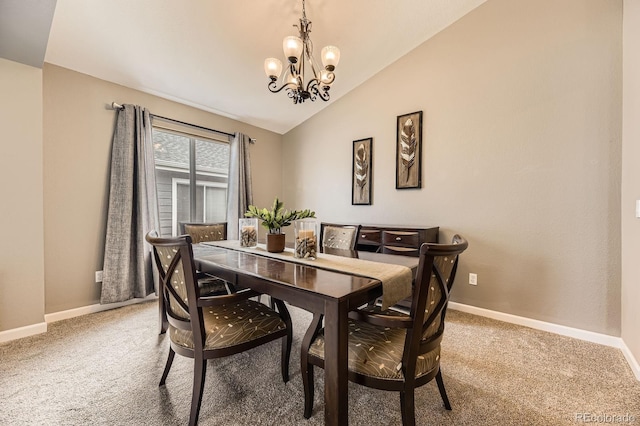 dining room with a chandelier, baseboards, light colored carpet, and vaulted ceiling