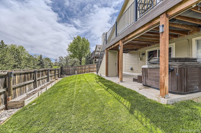 view of yard featuring a hot tub, a patio area, and a wooden deck