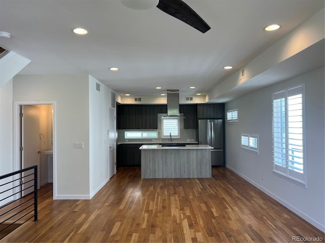 3404 W 18th Ave, Denver, CO 80204 - kitchen with freestanding refrigerator, ventilation hood, light countertops, a kitchen island, and dark wood-type flooring