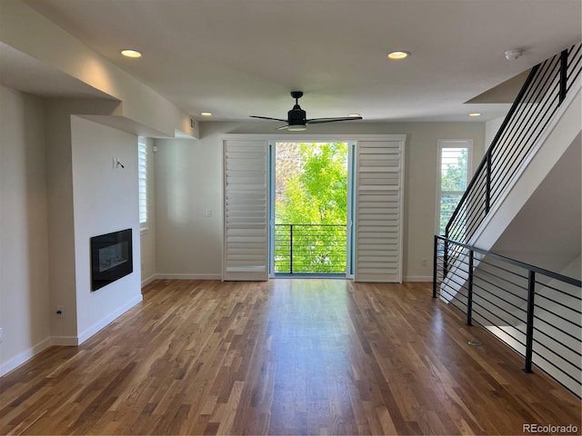3404 W 18th Ave, Denver, CO 80204 - unfurnished living room with baseboards, ceiling fan, wood finished floors, a glass covered fireplace, and recessed lighting
