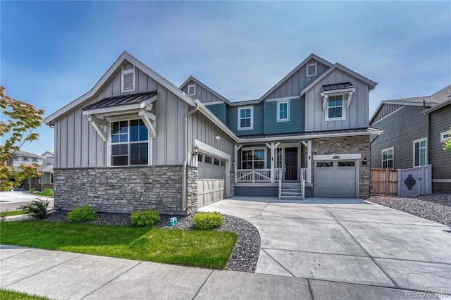 17194 Desert Wine Ln, Parker, CO 80134 - view of front facade featuring board and batten siding, stone siding, a standing seam roof, driveway, and a metal roof