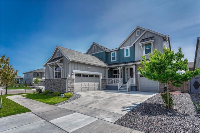 17194 Desert Wine Ln, Parker, CO 80134 - view of front facade featuring board and batten siding, stone siding, covered porch, driveway, and a standing seam roof