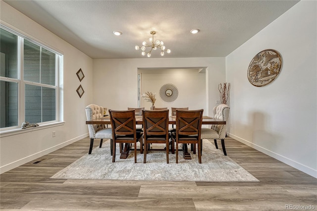17194 Desert Wine Ln, Parker, CO 80134 - dining area featuring a chandelier, wood finished floors, recessed lighting, and a textured ceiling