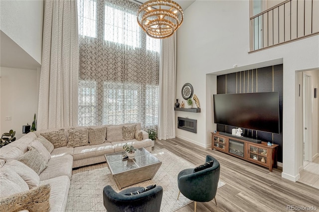17194 Desert Wine Ln, Parker, CO 80134 - living area featuring a high ceiling, a chandelier, and wood finished floors