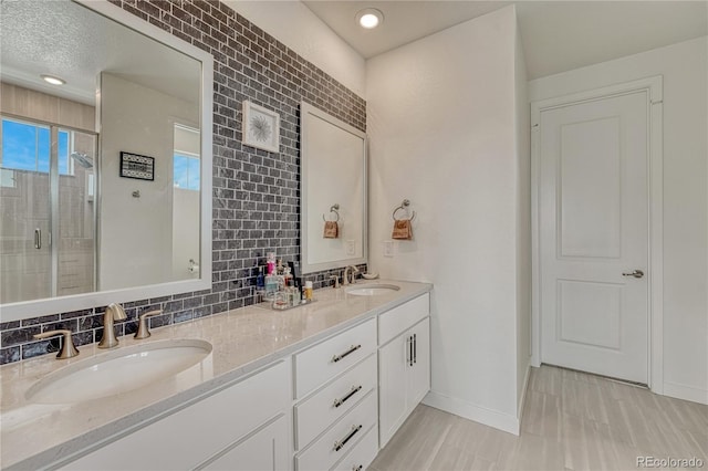 17194 Desert Wine Ln, Parker, CO 80134 - full bathroom with double vanity, a shower stall, and tasteful backsplash
