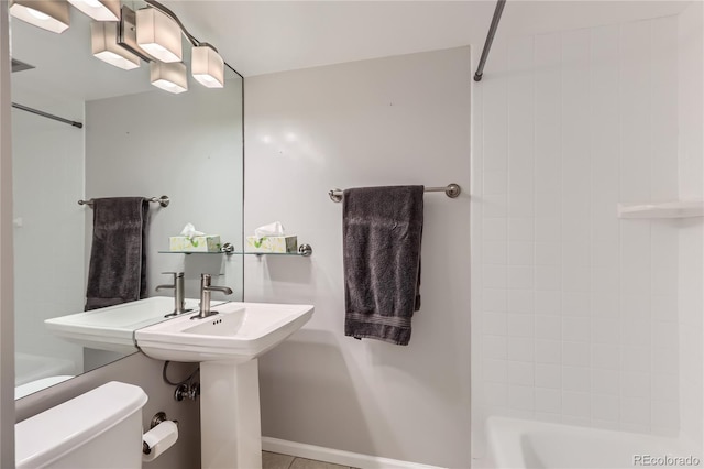 bathroom with washtub / shower combination and toilet