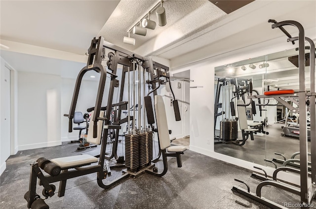 workout area featuring a textured ceiling