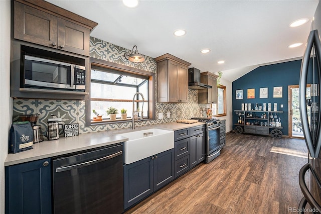 kitchen featuring sink, wall chimney exhaust hood, stainless steel appliances, plenty of natural light, and lofted ceiling