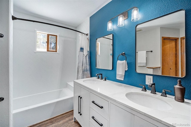 bathroom featuring vanity, hardwood / wood-style flooring, and shower / bath combo with shower curtain