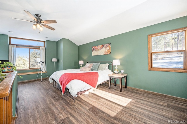 bedroom featuring ceiling fan, dark hardwood / wood-style floors, and vaulted ceiling