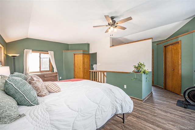 bedroom with hardwood / wood-style flooring, ceiling fan, and lofted ceiling