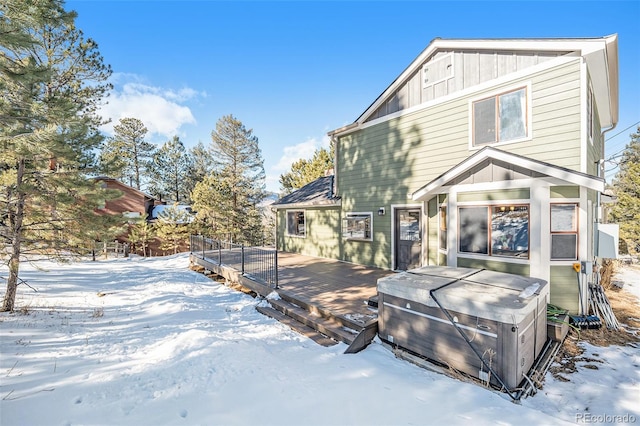 snow covered property with a wooden deck