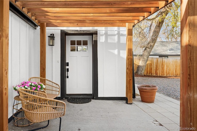 doorway to property featuring a patio area and fence